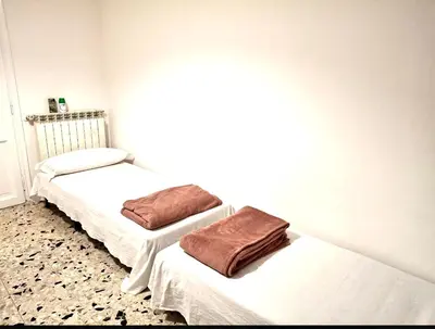 a bedroom with two beds with towels on them at Baraka 24 in Rome