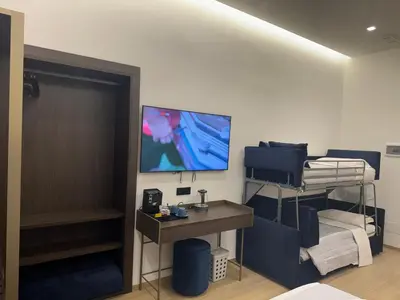 a room with a bed and a tv on a wall at santa maria maggiore luxury guest house in Rome