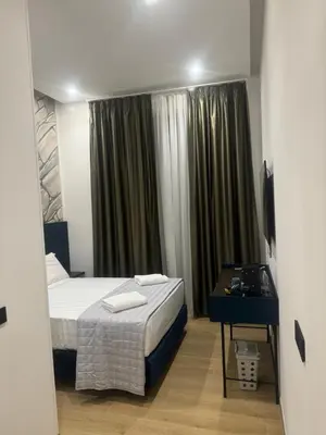 a bedroom with a bed and a desk and a window at santa maria maggiore luxury guest house in Rome