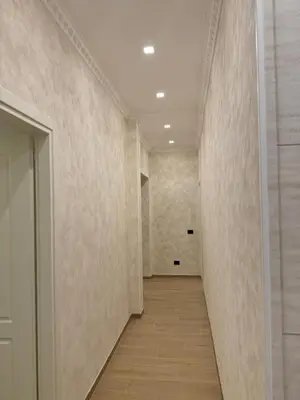 a hallway with white walls and a wooden floor at santa maria maggiore luxury guest house in Rome