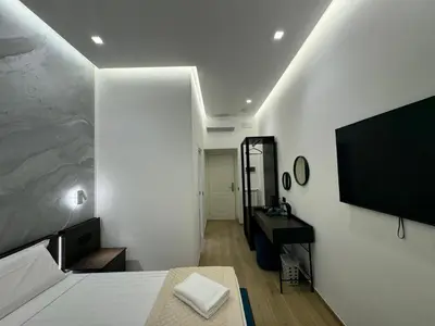 a bedroom with a bed and a flat screen tv at santa maria maggiore luxury guest house in Rome