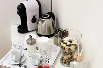 a table with cups and cups and a coffee maker at B&B Behind the Vatican in Rome