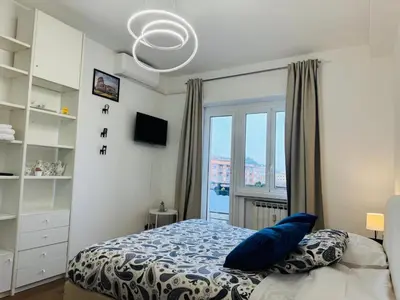 a bedroom with a bed with a blue pillow and a window at B&B Behind the Vatican in Rome