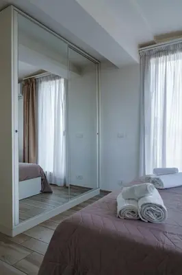 a bedroom with a large mirror and a bed at Ginevra Apartment in Rome in Rome