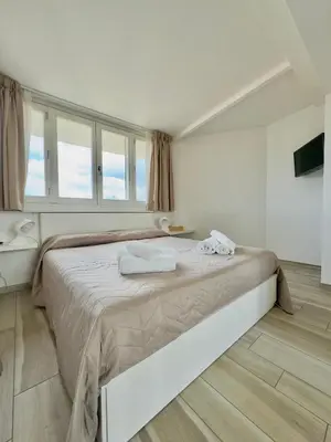 a bedroom with a large bed with towels on it at Ginevra Apartment in Rome in Rome