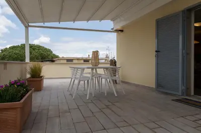 a white table and chairs on a patio at Ginevra Apartment in Rome in Rome