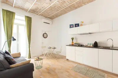 a living room with a couch and a kitchen at Al Centro di Roma - Vaticano in Rome
