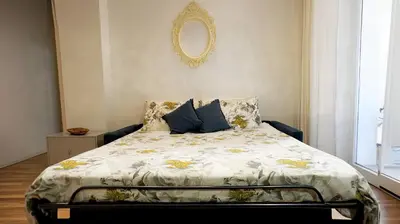 a bedroom with a large bed with a white comforter at Al Centro di Roma - Vaticano in Rome