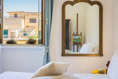 a mirror in a room with a window with a view at Amazing Penthouse Vaticano in Rome