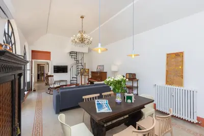 a living room with a table and a couch at Amazing Penthouse Vaticano in Rome