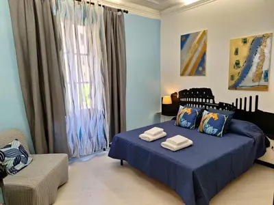 a bedroom with a blue bed with towels on it at Re di Roma nice rooms in Rome