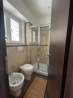 a bathroom with a toilet and a shower and a sink at La Casetta di Ponte Milvio con parcheggio in Rome