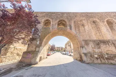 an archway in an old stone building with a street at Casa Piazza Lodi in Rome