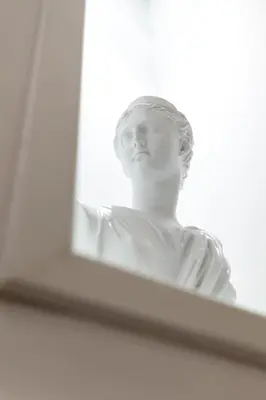 a statue of a woman looking out of a window at Saint John Loft in Rome