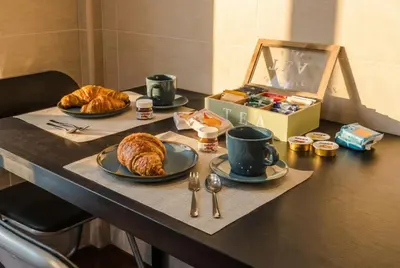 a table with two plates of food and a box of croissants at Saint John Loft in Rome