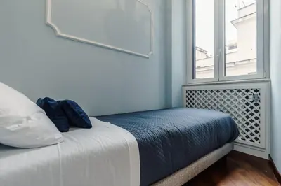 a bed in a room with a window at Saint John Loft in Rome
