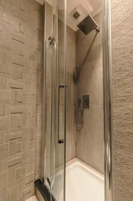 a bathroom with a shower with a tub at Saint John Loft in Rome