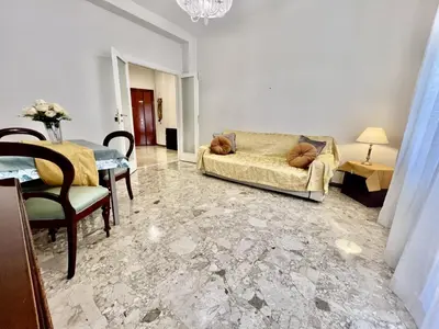 a living room with a couch and a table at Luxury apartment San Giovanni in Rome