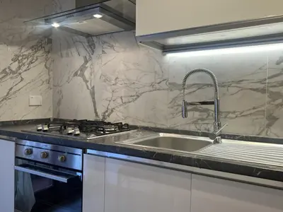 a kitchen with a sink and a stove at Luxury apartment San Giovanni in Rome
