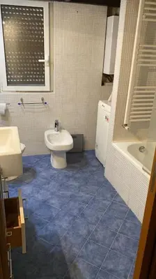 a bathroom with a toilet and a sink and a tub at Caffa Apartment in Rome