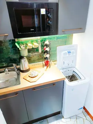 a kitchen counter with a sink and a microwave at Betania Loft in Rome