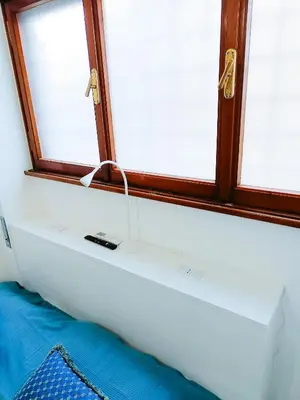 a window with a remote control on top of a couch at Betania Loft in Rome