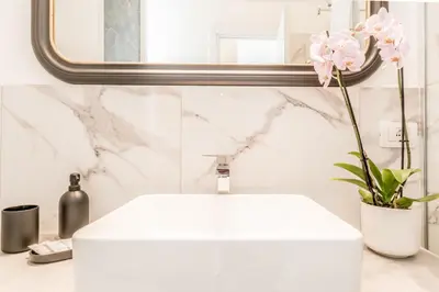 a bathroom with a white sink and a mirror at Apartment Maison 170 - Rome in Rome