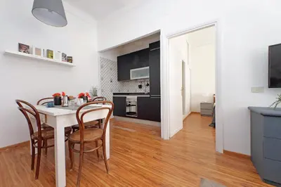 a kitchen and dining room with a table and chairs at Testaccio - Pretty Apartment in Rome