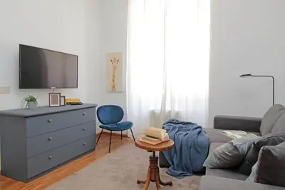 a living room with a couch and a dresser with a tv at Testaccio - Pretty Apartment in Rome