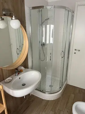 a bathroom with a glass shower and a sink at LoveRhome Apartment 10 in Rome