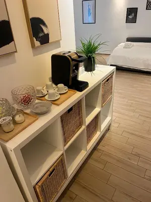 a white cabinet with a microwave on top of it at LoveRhome Apartment 10 in Rome