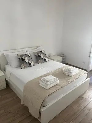 a bedroom with a white bed with towels on it at LoveRhome Apartment 10 in Rome