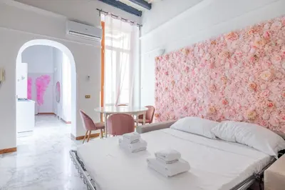 a bedroom with a white bed and a table at maison Trevi in Rome