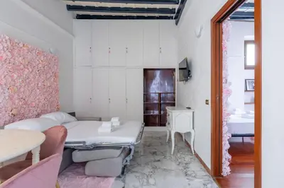 a small room with a bed and a table at maison Trevi in Rome