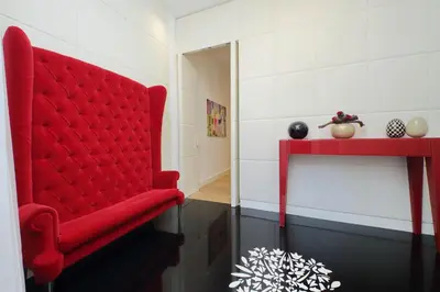 a red chair in a room with a red table at Domus Aurea Luxury Suites in Rome