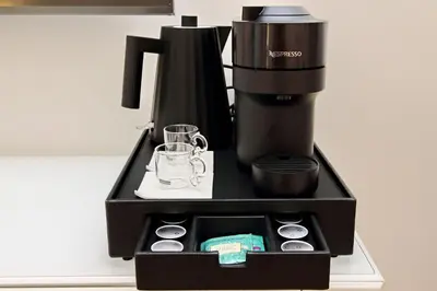 a black coffeemaker sitting on top of a counter at Domus Aurea Luxury Suites in Rome