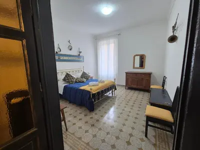 a bedroom with a bed and a table and a chair at Casa di Bea in Rome