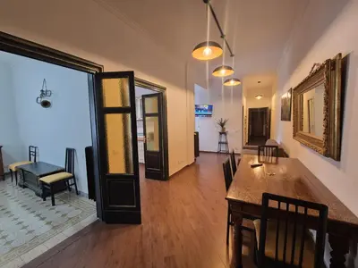 a living room with a table and a dining room at Casa di Bea in Rome