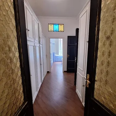 an empty hallway with a door and a window at Casa di Bea in Rome
