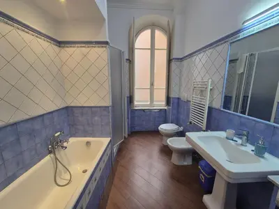 a bathroom with a tub and a sink and a toilet at Casa di Bea in Rome