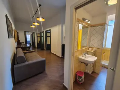 a living room with a couch and a sink at Casa di Bea in Rome