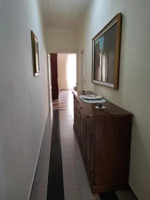 a bathroom with a wooden dresser in a room at Iannilli Casa Vacanze in Rome
