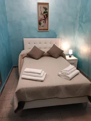 a bedroom with a bed with towels on it at Iannilli Casa Vacanze in Rome
