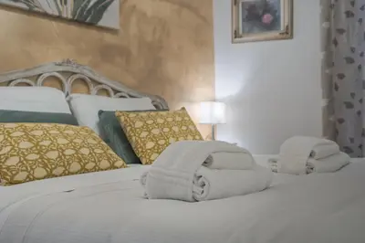 a bedroom with a bed with towels on it at Piazza del Popolo - The Heart of Rome in Rome