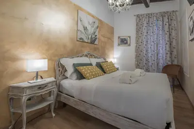 a bedroom with a bed and a table with a lamp at Piazza del Popolo - The Heart of Rome in Rome