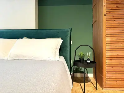 a bedroom with a bed and a green wall at Luxury Apartment Historic Center in Rome