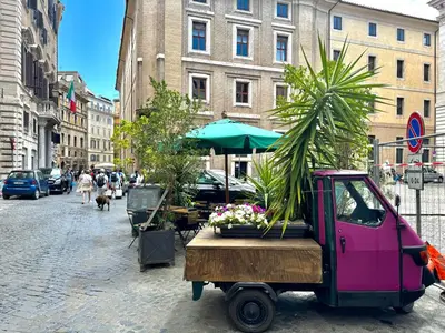 a pink truck with plants on a city street at Luxury Apartment Historic Center in Rome