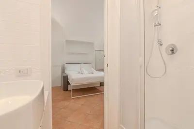 a bathroom with a bath tub and a bed at Cozy Rhome in Rome