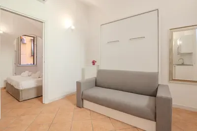 a living room with a couch and a bed at Cozy Rhome in Rome