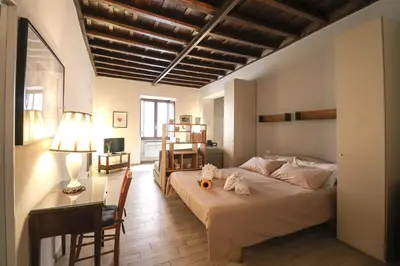 a bedroom with a bed and a desk with a lamp at Ciambella Cozy Flat in Rome